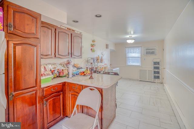 kitchen featuring light countertops and a peninsula