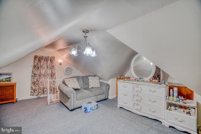 interior space featuring lofted ceiling and carpet floors