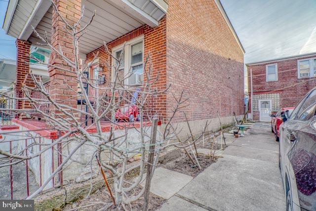 view of side of property featuring brick siding