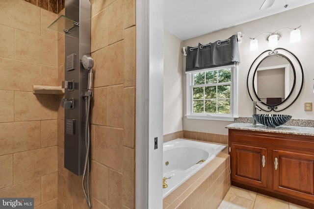 bathroom featuring vanity, tile patterned flooring, and separate shower and tub