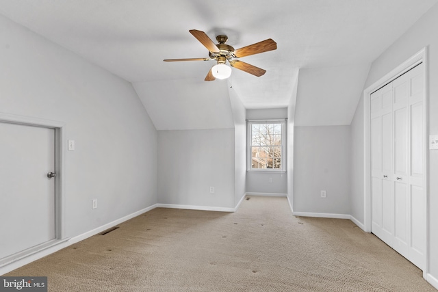 bonus room featuring ceiling fan, vaulted ceiling, and light carpet