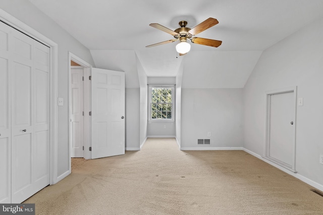 unfurnished bedroom with lofted ceiling, light carpet, and ceiling fan