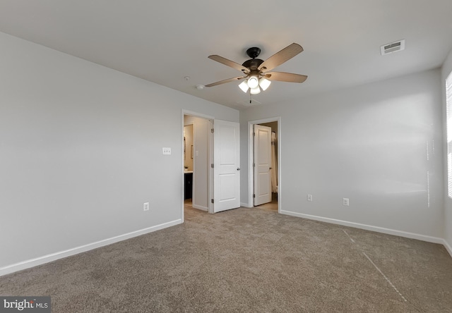 unfurnished bedroom with carpet floors, visible vents, ceiling fan, and baseboards