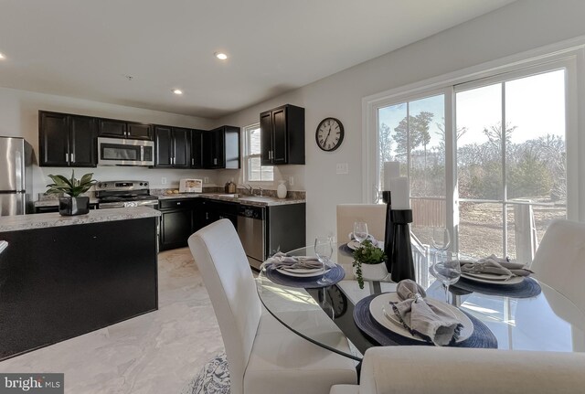 dining space featuring recessed lighting and marble finish floor