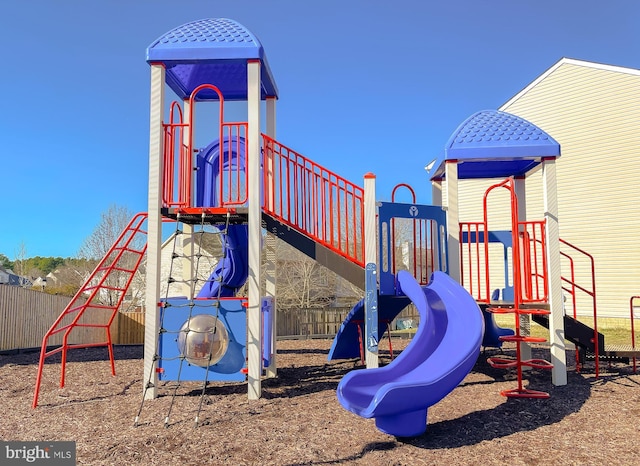 view of jungle gym featuring fence