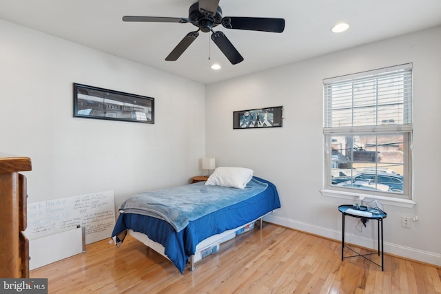 bedroom with ceiling fan and light hardwood / wood-style floors