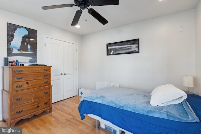 bedroom featuring light hardwood / wood-style floors, a closet, and ceiling fan