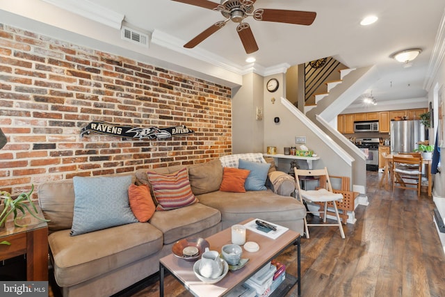 living room featuring ceiling fan, crown molding, brick wall, and dark hardwood / wood-style floors