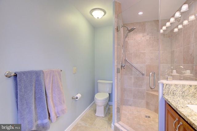 bathroom with tile patterned floors, vanity, toilet, and an enclosed shower