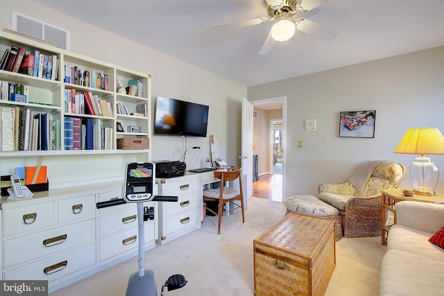 living room featuring ceiling fan and light carpet