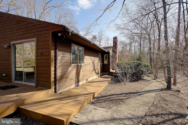 view of home's exterior with a wooden deck