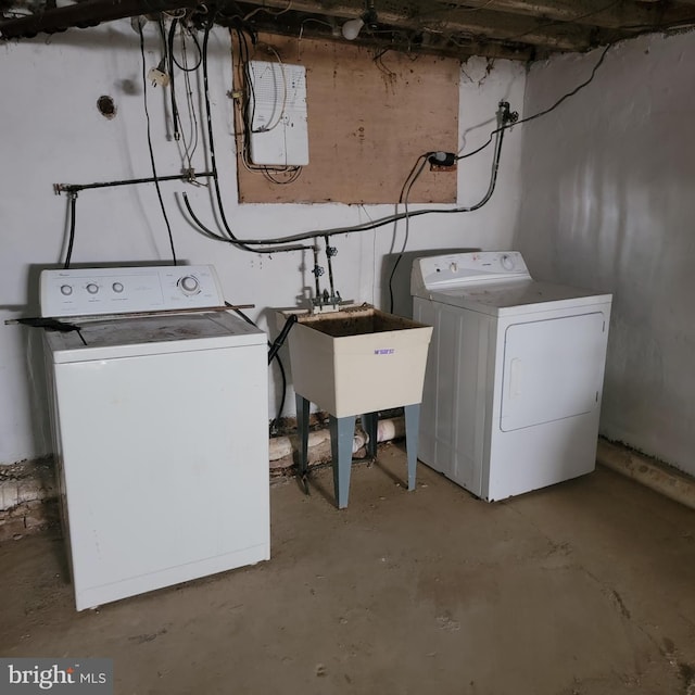 washroom with laundry area, a sink, and washer and clothes dryer