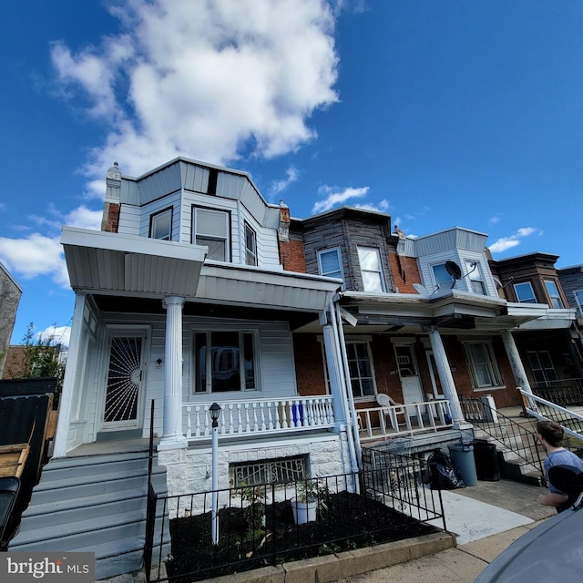 townhome / multi-family property with covered porch