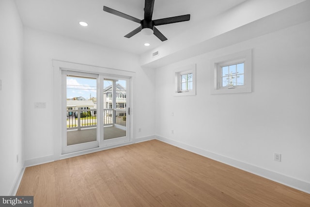spare room with recessed lighting, a ceiling fan, visible vents, light wood-style flooring, and baseboards