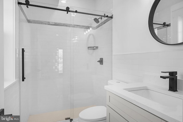 full bath with toilet, a stall shower, tile walls, and vanity