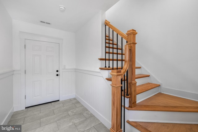 interior space featuring visible vents, wainscoting, and tile patterned floors