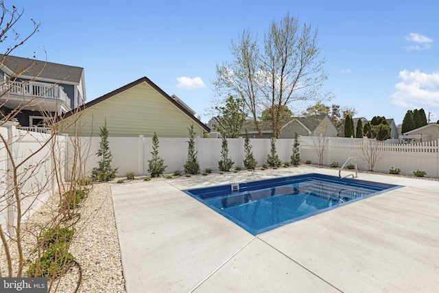 view of swimming pool featuring a fenced in pool, a patio area, and a fenced backyard