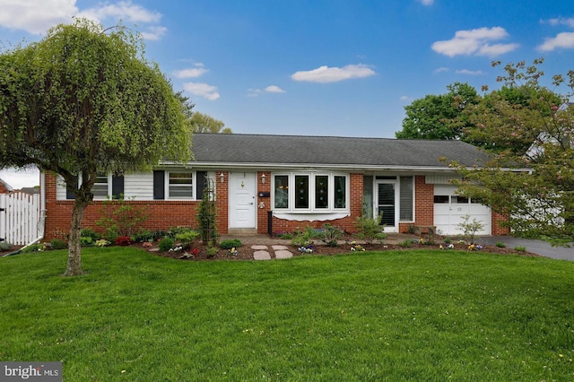 ranch-style home with brick siding, an attached garage, and aphalt driveway