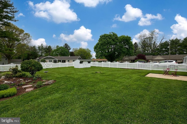 view of yard with an outdoor structure and a fenced backyard