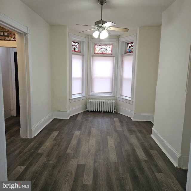 unfurnished dining area with radiator, a wealth of natural light, dark hardwood / wood-style floors, and ceiling fan