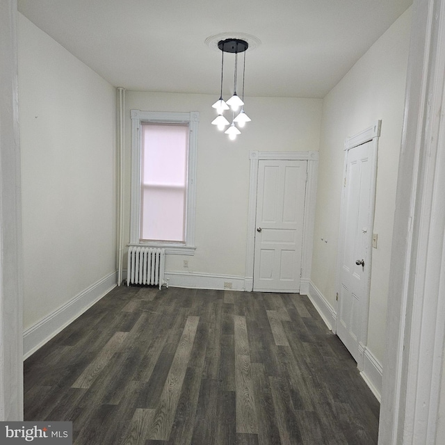 unfurnished dining area featuring radiator and dark hardwood / wood-style floors