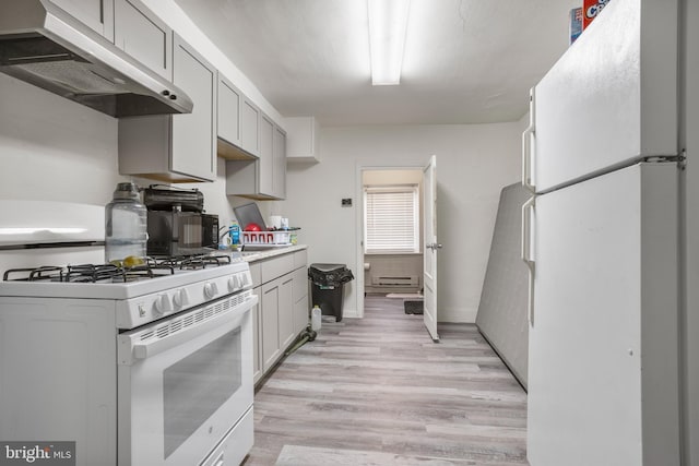 kitchen featuring white appliances and light hardwood / wood-style flooring