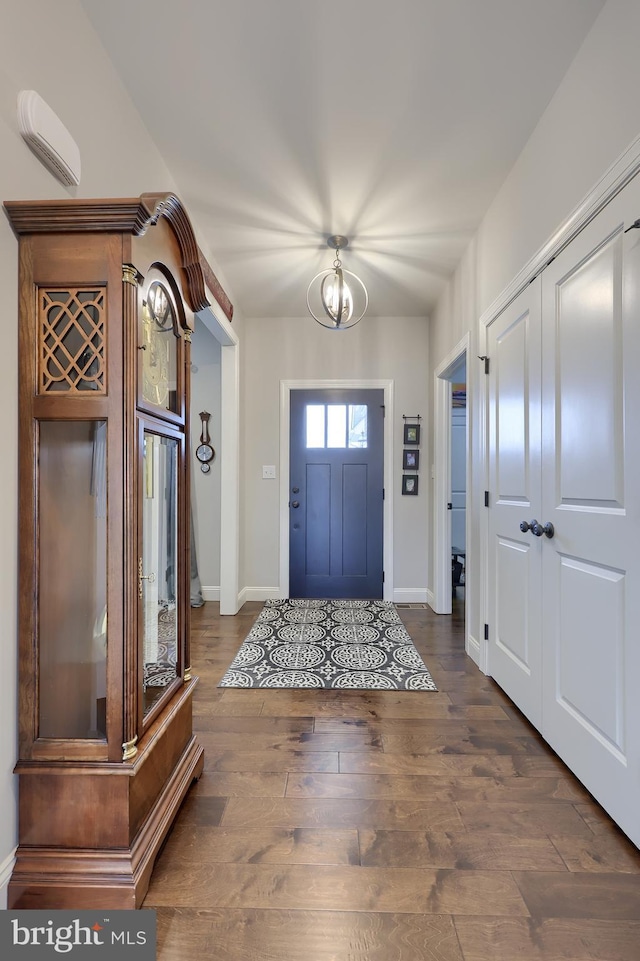 entrance foyer featuring wood finished floors and baseboards