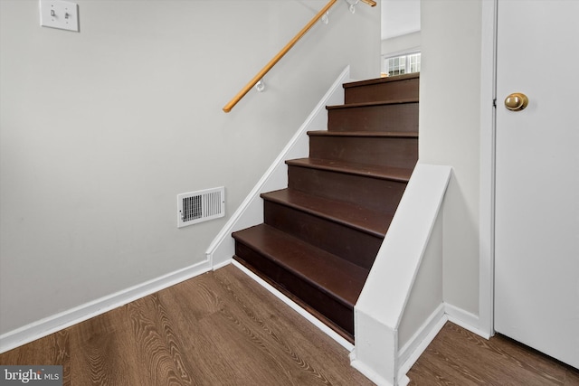 stairway featuring hardwood / wood-style floors