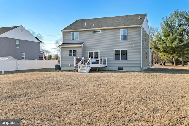 back of property featuring central AC unit, fence, a lawn, and a wooden deck