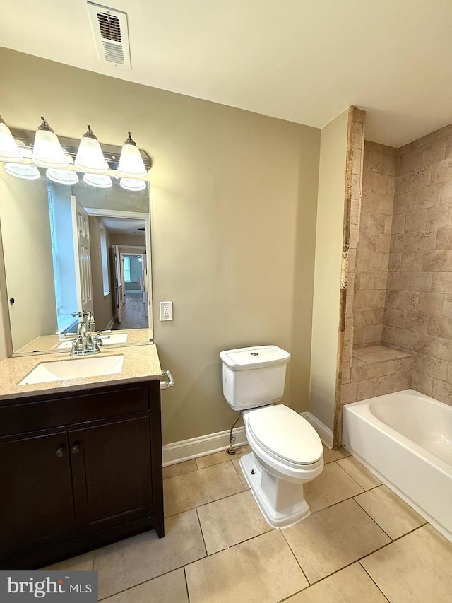 full bathroom with tile patterned flooring, vanity, tiled shower / bath combo, and toilet