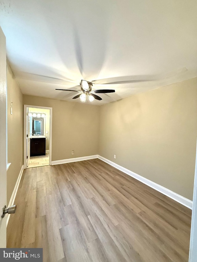 empty room featuring light hardwood / wood-style floors and ceiling fan