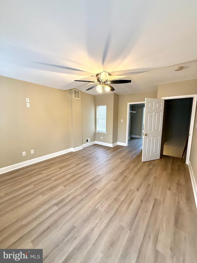 unfurnished room with light hardwood / wood-style flooring and ceiling fan