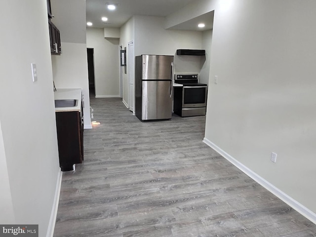 kitchen featuring stainless steel appliances and light hardwood / wood-style flooring