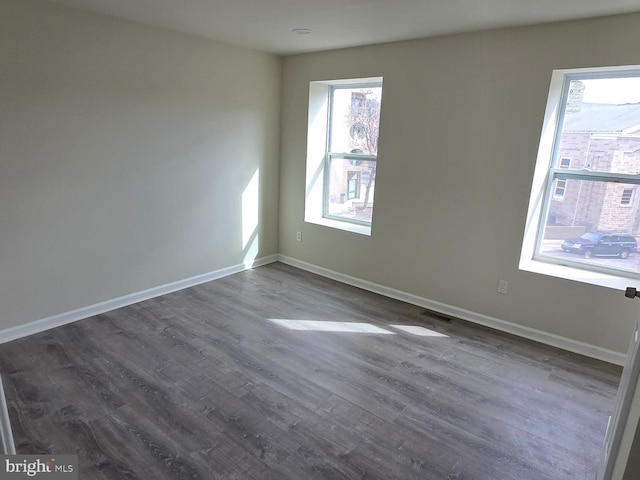 empty room with hardwood / wood-style floors