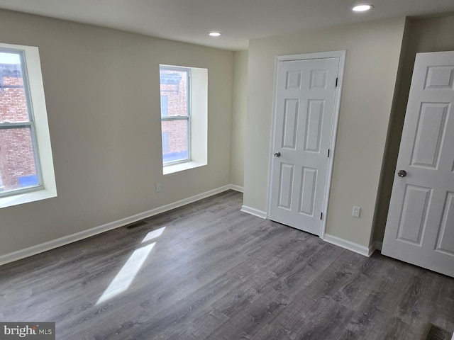 empty room featuring dark wood-type flooring