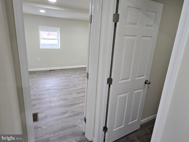 corridor featuring hardwood / wood-style floors