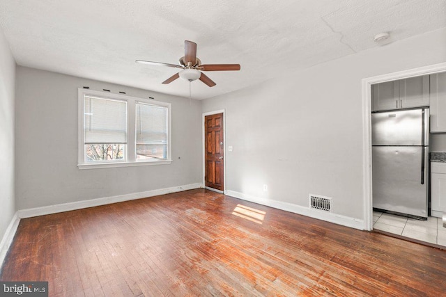 spare room featuring hardwood / wood-style flooring and ceiling fan