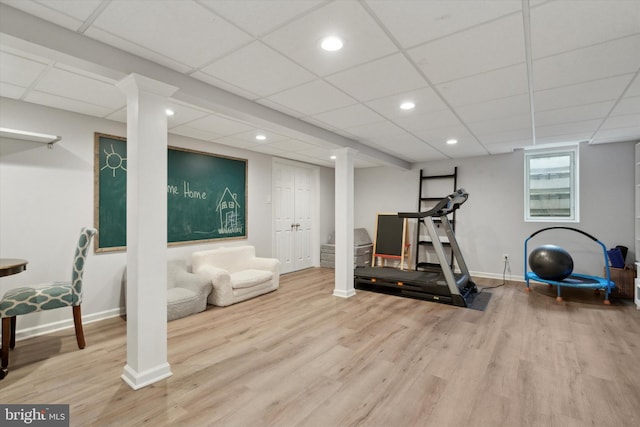 exercise area featuring hardwood / wood-style flooring and a paneled ceiling