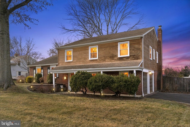 view of property with a yard and a garage