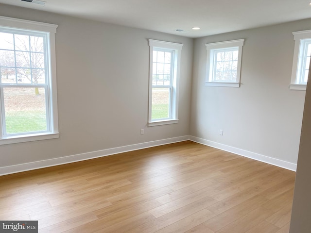 spare room featuring light hardwood / wood-style floors