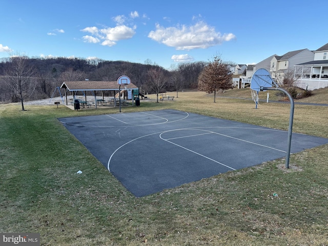 view of sport court with a yard