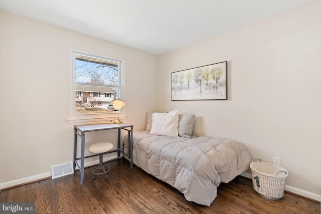 bedroom with dark wood-type flooring