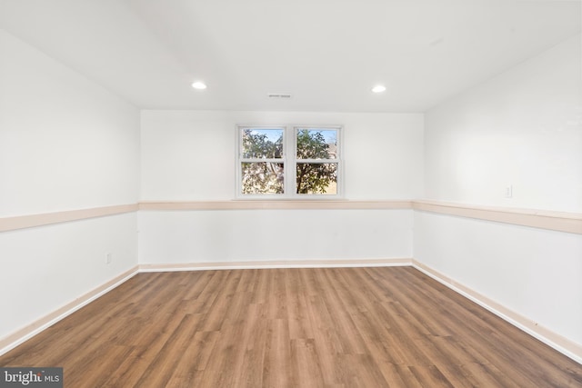 unfurnished room with hardwood / wood-style flooring