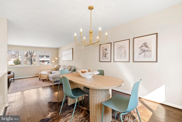 dining space featuring an inviting chandelier and dark hardwood / wood-style floors