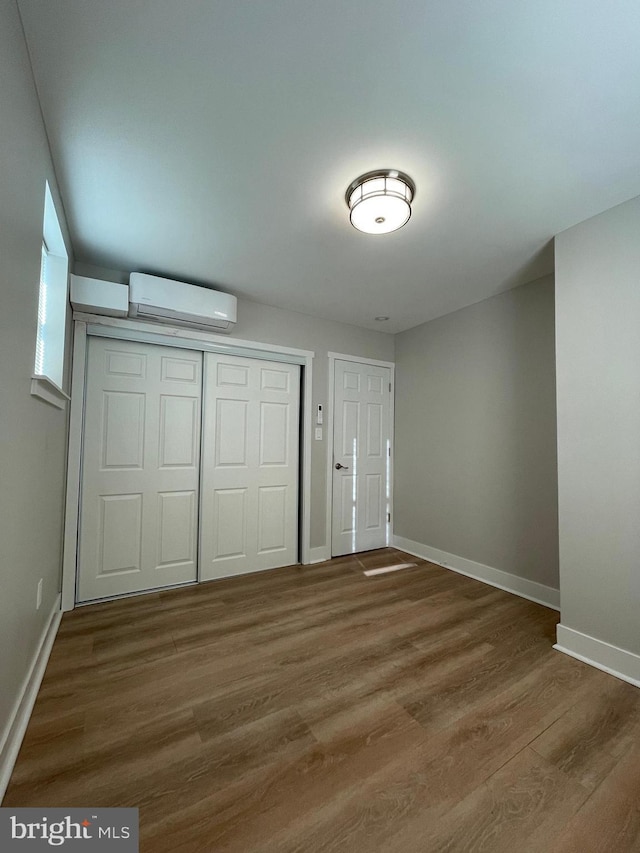 entryway featuring hardwood / wood-style flooring and a wall mounted AC