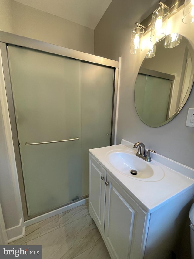 bathroom with a shower with door and vanity