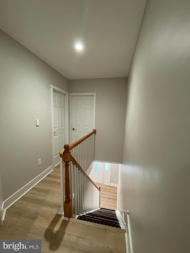 stairs with hardwood / wood-style flooring