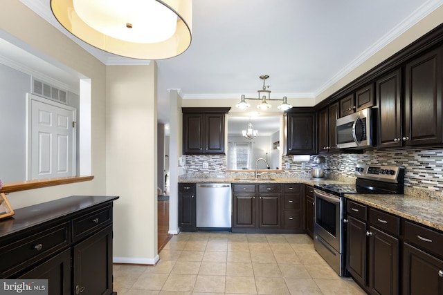 kitchen featuring light tile patterned floors, visible vents, decorative backsplash, stainless steel appliances, and a sink