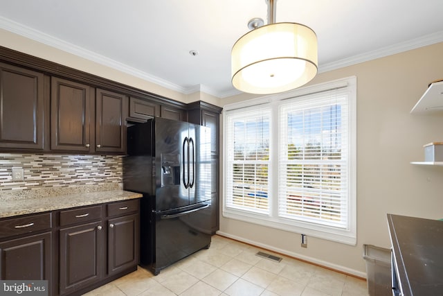 kitchen with dark brown cabinetry, black fridge with ice dispenser, visible vents, ornamental molding, and backsplash