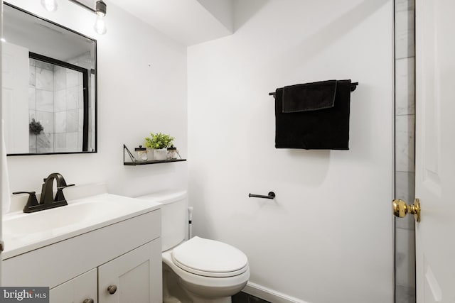 full bathroom with toilet, an enclosed shower, and vanity